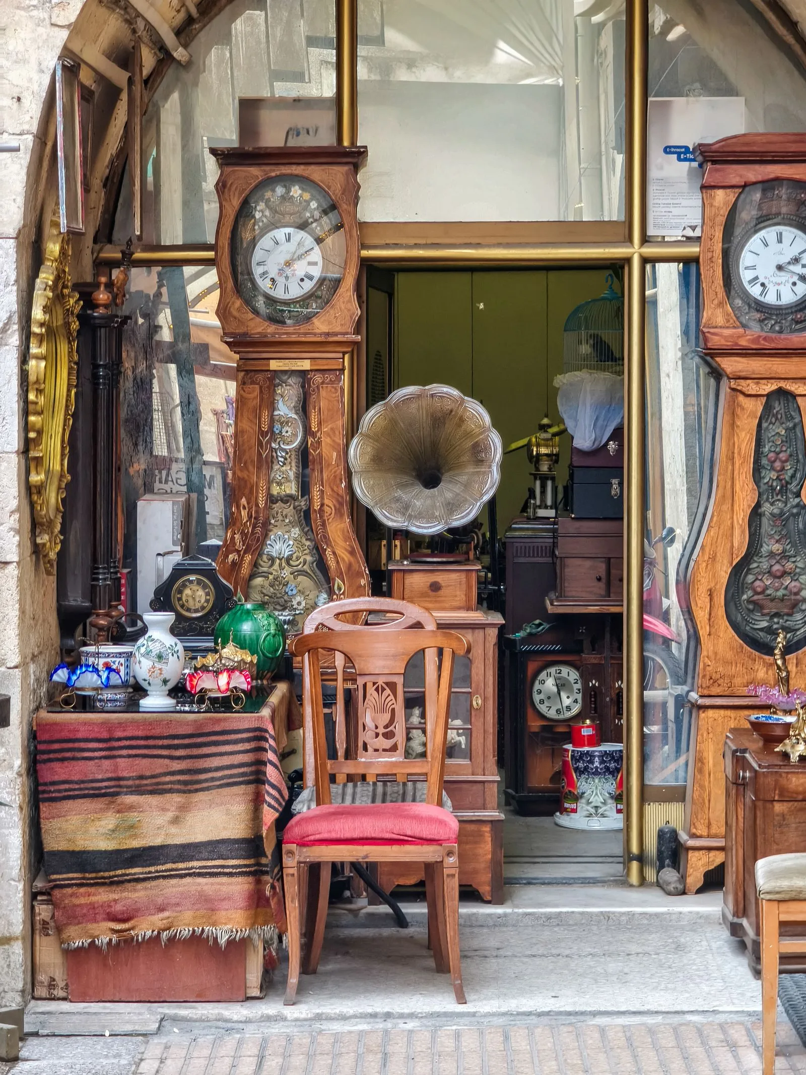 Staande klokken, een grammofoon en een houten stoel